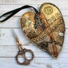 Embroidered up-cycled gold heart home decoration. 