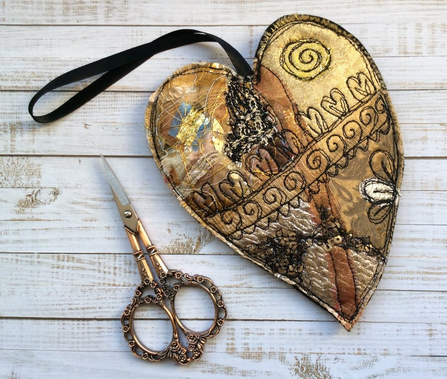 Embroidered up-cycled gold heart home decoration. 