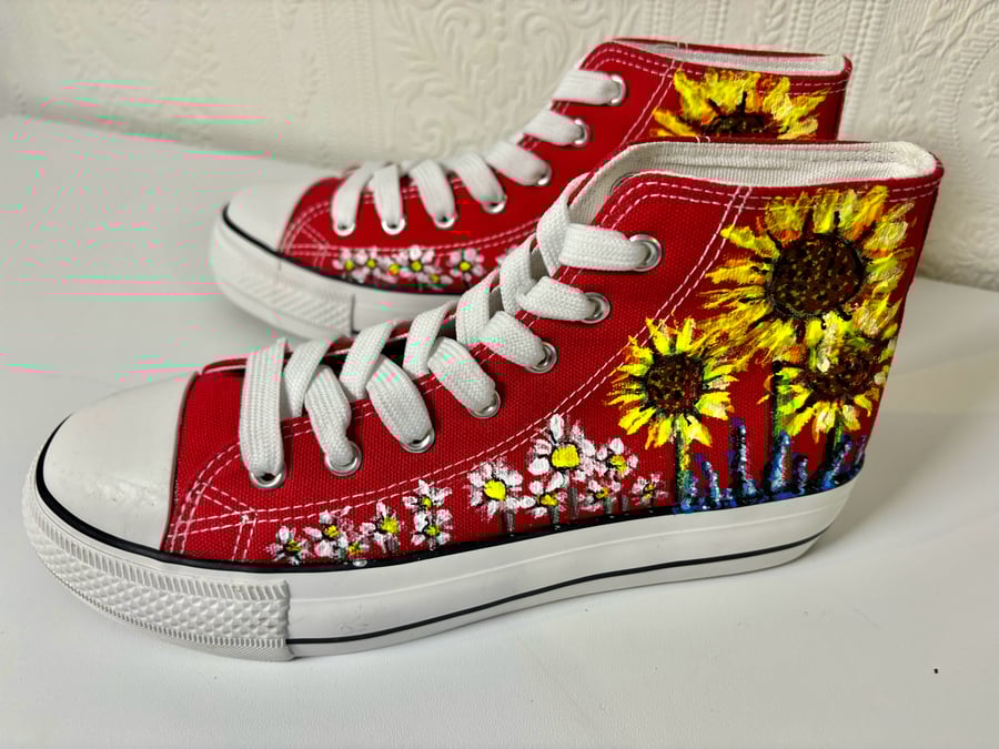 A pair of hand painted and sealed high tops by Andrew Jenkins 