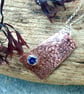 Copper pebble textured pendant with blue stone - Image 1