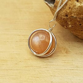 Small 3d circle Sunstone pendant necklace. 10mm Peach semi precious stone