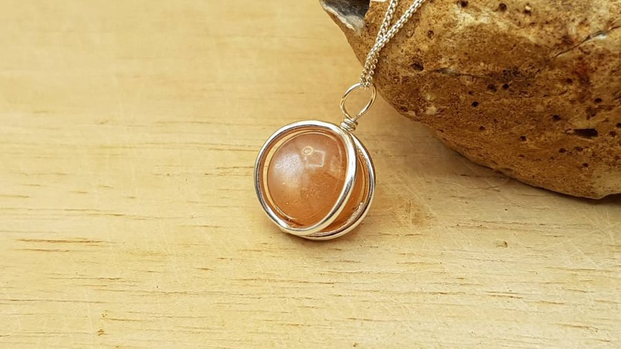 Small 3d circle Sunstone pendant necklace. 10mm Peach semi precious stone