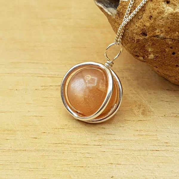 Small 3d circle Sunstone pendant necklace. 10mm Peach semi precious stone