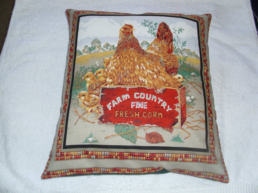 Chicken in a crate with chicks in a farmyard cushion 