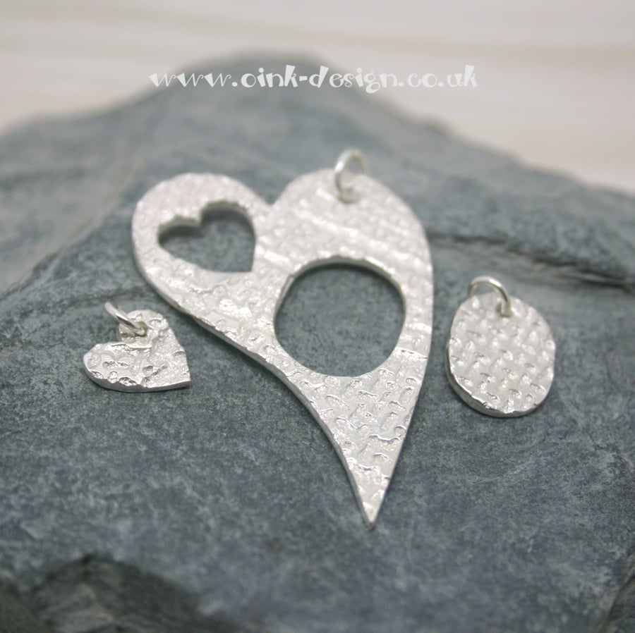 Mummy and Me. Three fine silver patterned pendants