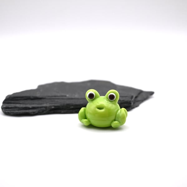 small glass frog figure