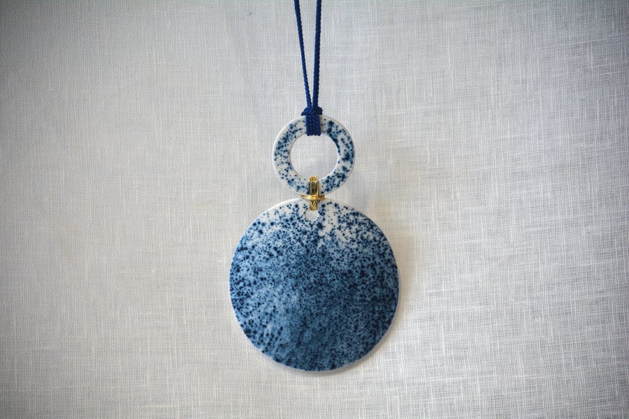 Porcelain pendant with blue stain detail with the shapes connected with wire