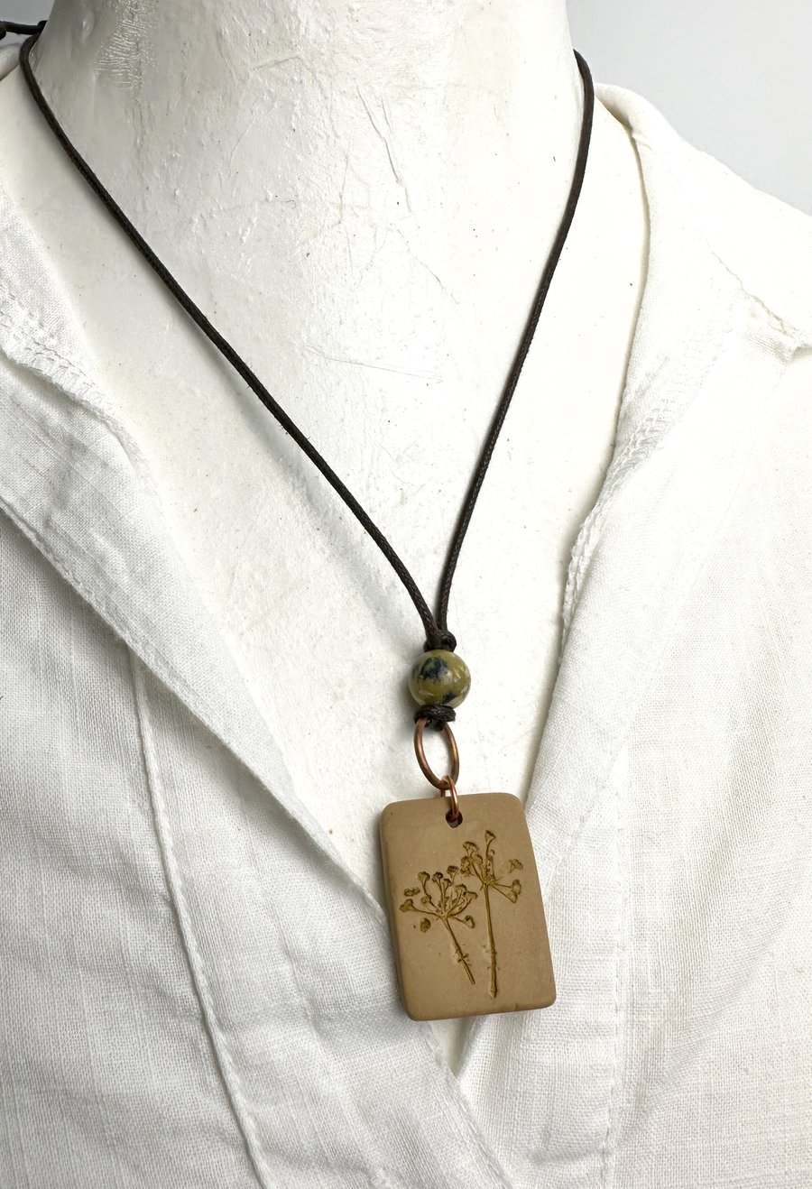 Pressed Fennel Flower Pendant with a turquoise stone and adjustable cord. 