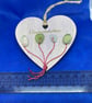 Wooden heart with 'congratulations' sentiment made using  with sea glass.