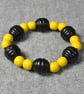 Black wooden Beehive Bead and Yellow Wooden Round Bead Elastic Bracelet
