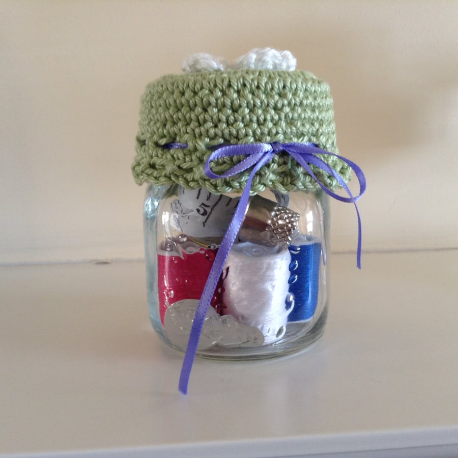 Glass jar with sewing accessories