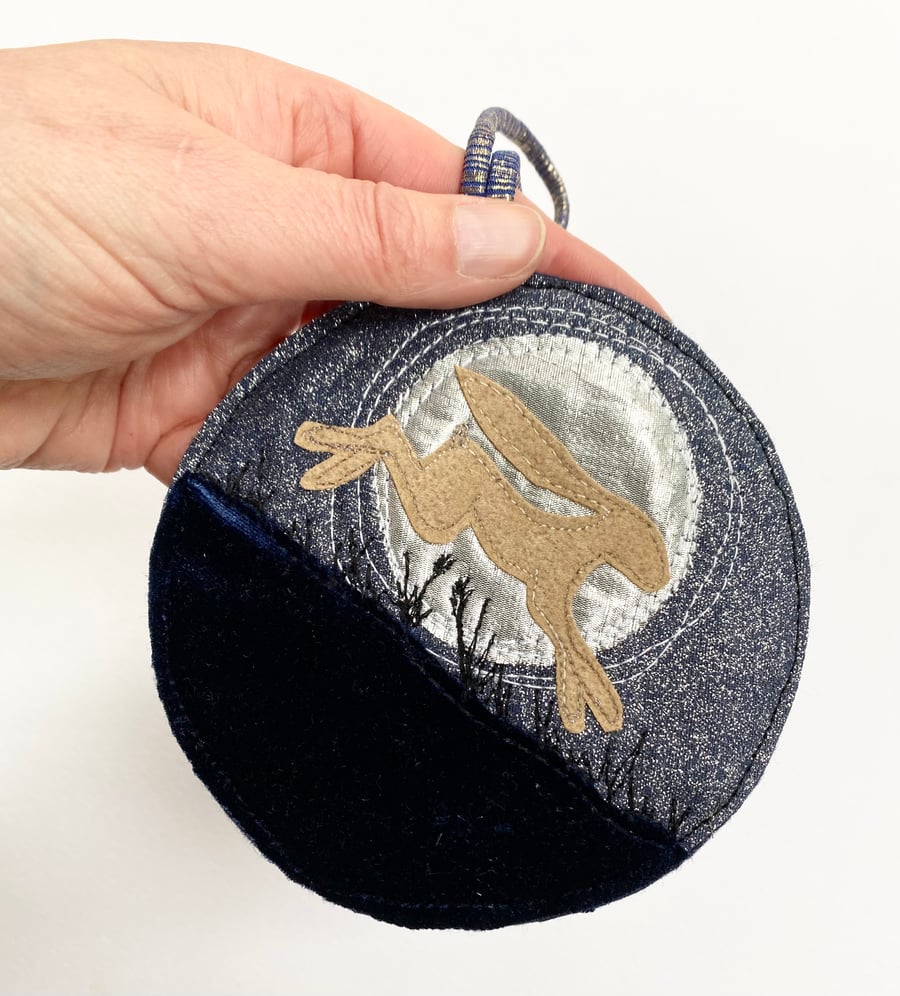 Upcycled embroidered running hare and full moon home decoration. 