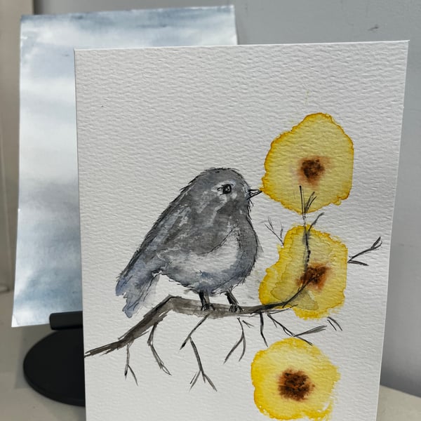 Bird on a perch with yellow flowers