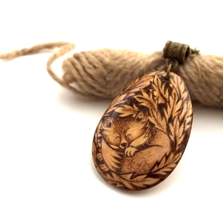 Fox in a bed of leaves, wooden pyrography teardrop pendant.