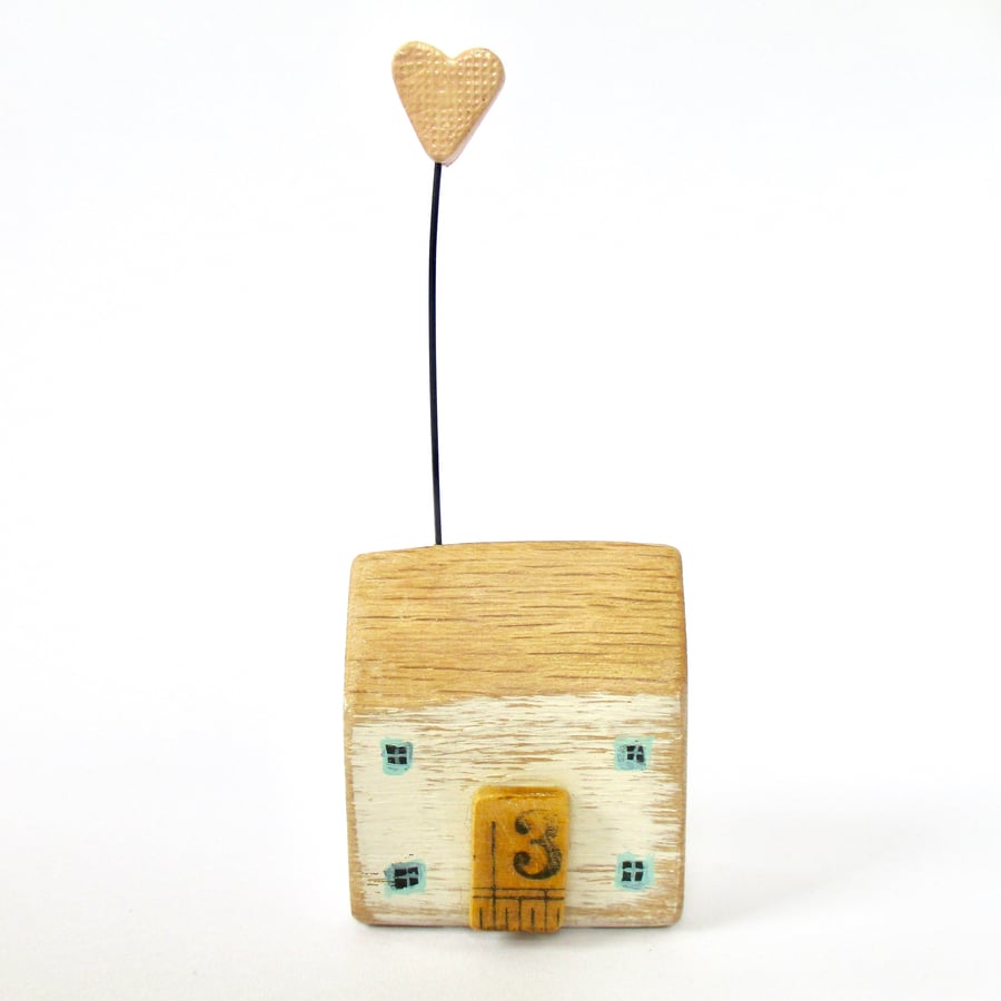 Little wooden house with a clay heart