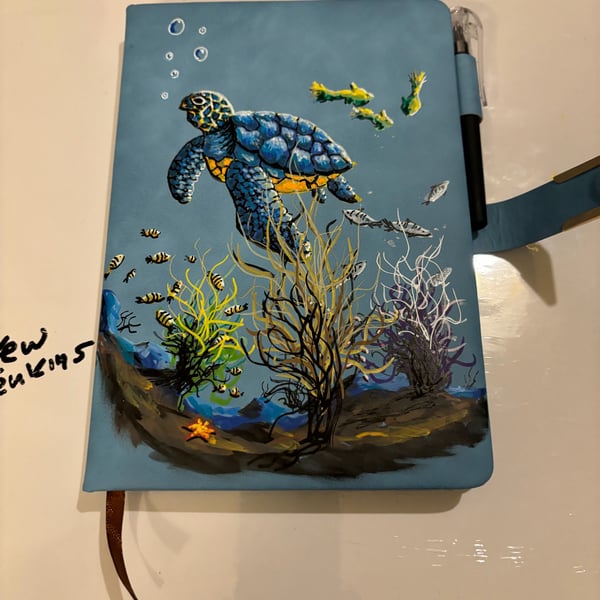 A hand painted and sealed faux leather journal by Andrew Jenkins 