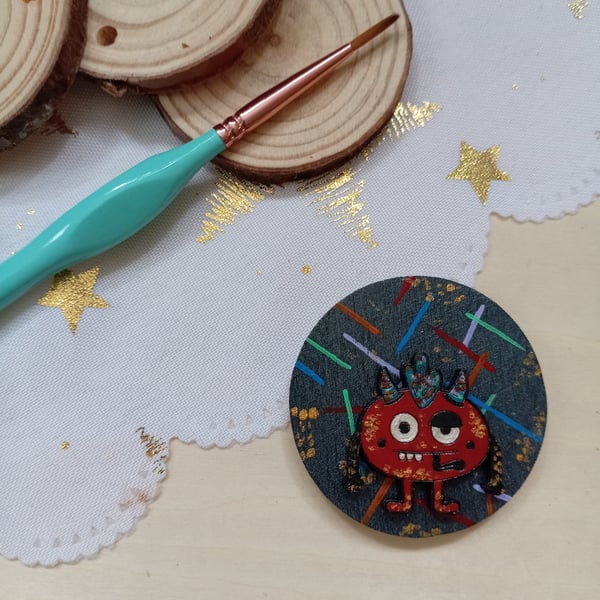 Wooden circular red monster fridge magnet 