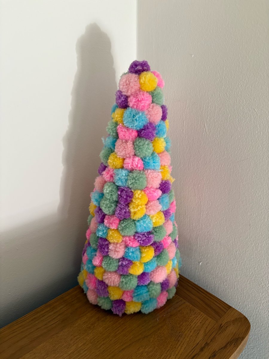 Pastel rainbow Pom Pom decorated cone. 