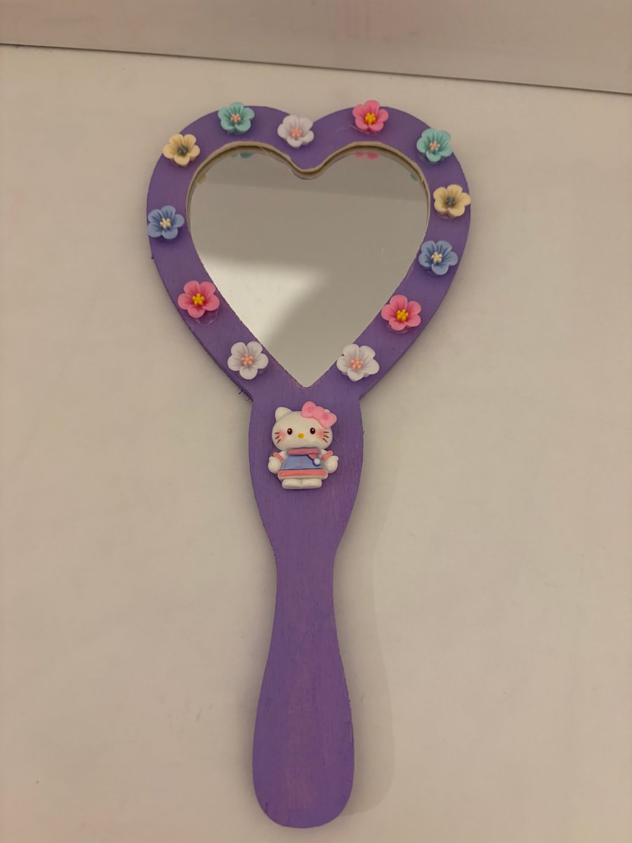 Hand held hand decorated wood mirror. 