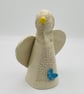 Angel sculpture with blue butterfly & yellow flower - Image 3