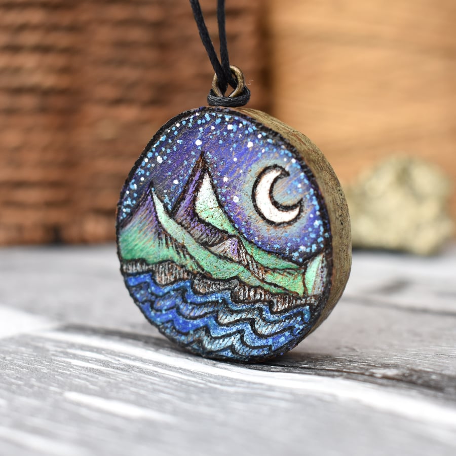Moonlight over the mountains & seas pyrography wood branch pendant.