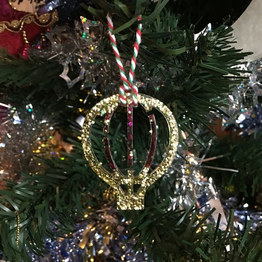 Hot air balloon Christmas tree decoration with gold and purple glitter.