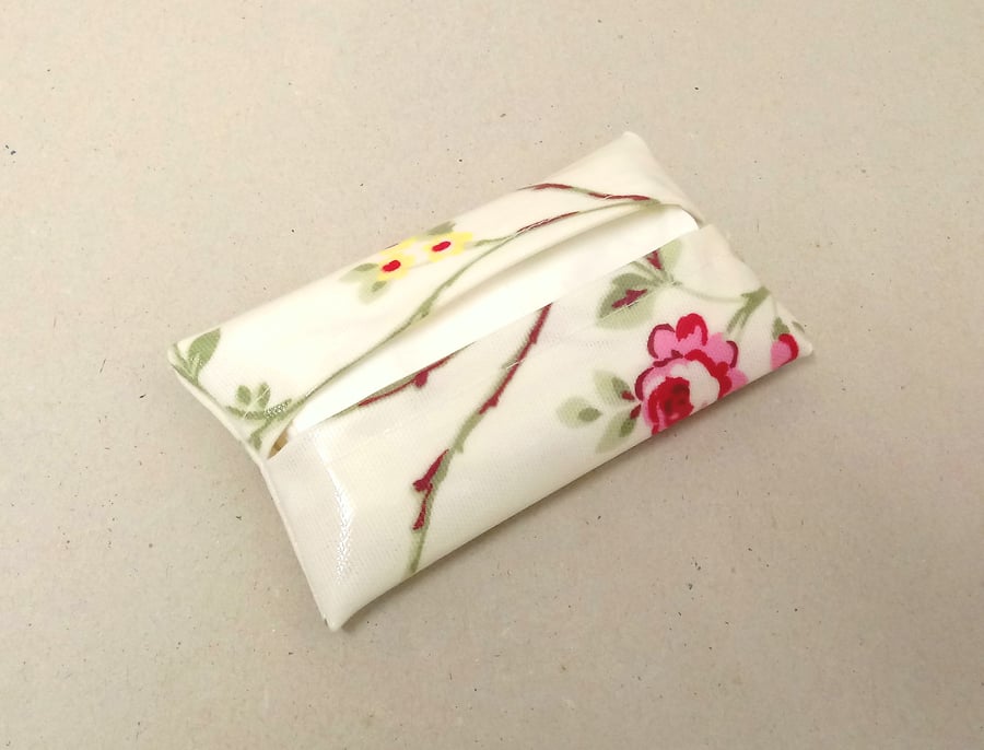 Tissue holder in white with flowers and a pink butterfly, tissues included.