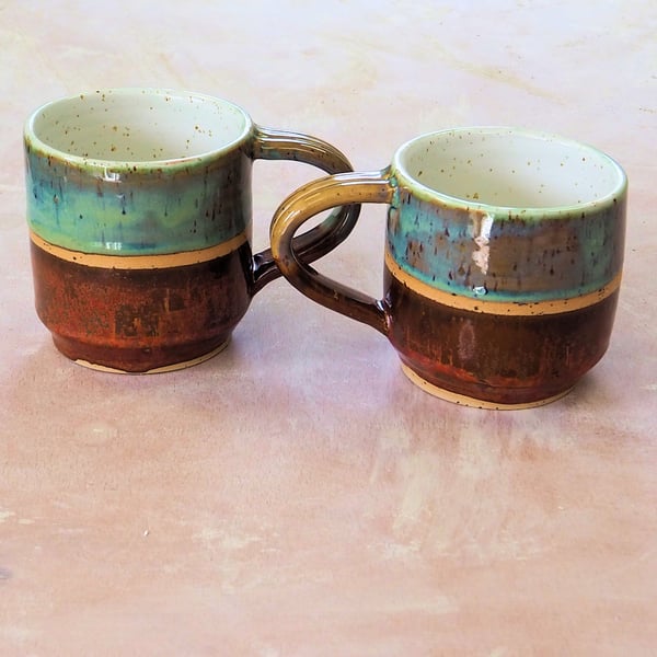 Stoneware pottery mug finished in a Turquoise and Copper colour glazes.