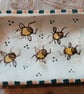 Square slip ware dish with hand painted bee design