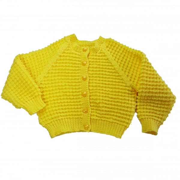 Yellow child's cardigan hand knitted with all over textured pattern 1-2 yrs