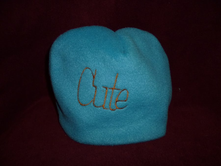 Hand made sewn baby hat in soft fleece fabric -blue with orange cute design