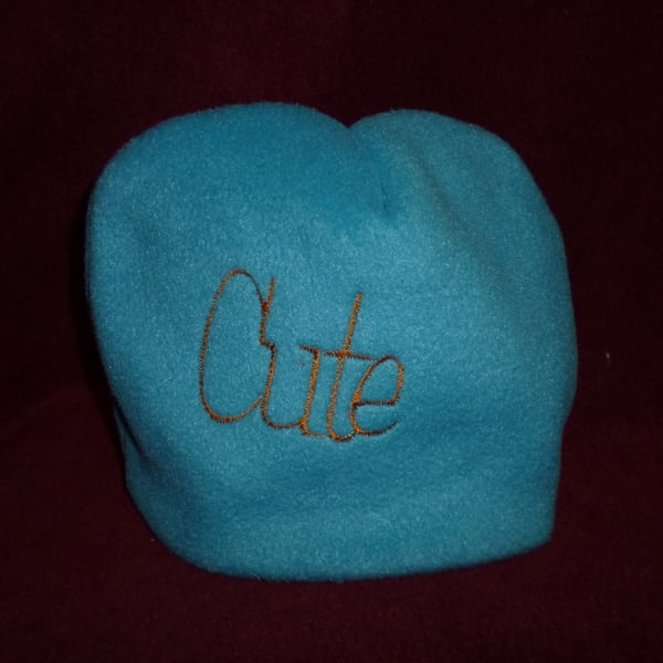 Hand made sewn baby hat in soft fleece fabric -blue with orange cute design