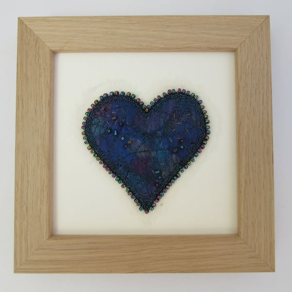 Blue love heart picture.  Turquoise and blue fabric heart with beaded edge