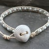 Ceramic shell button, leather and glass bead bracelet, silver and pale blue