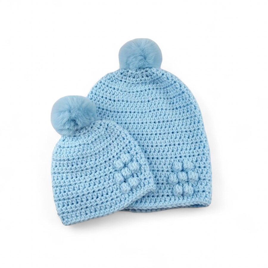 Matching ladies and baby blue crocheted hats with detachable faux fur pompoms 