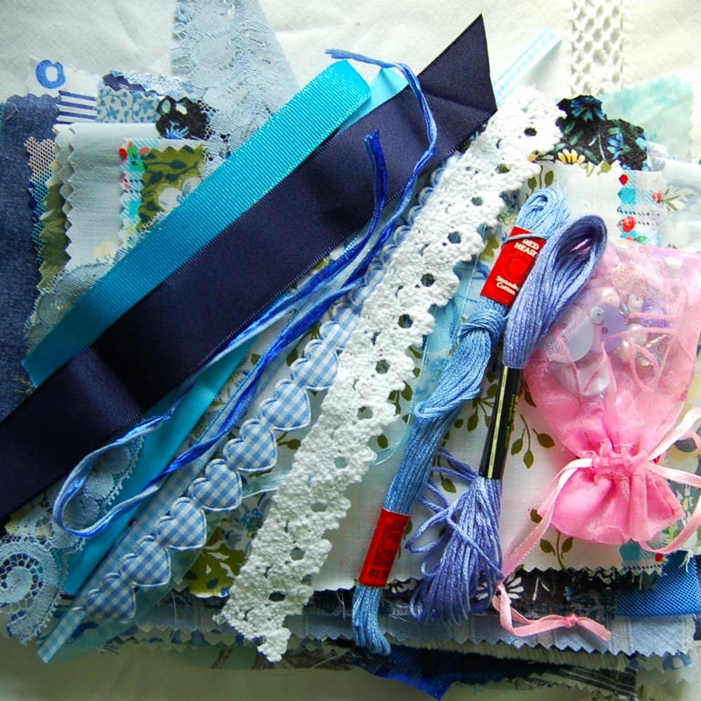 Upcycled slow stitching kit includes fabric, buttons, thread, lace, ribbon
