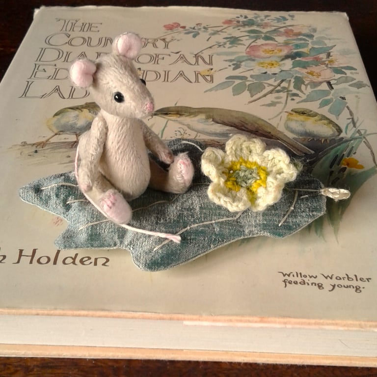 Miniature mouse 'Primrose' fully jointed, hand stitched sitting on a silk leaf.