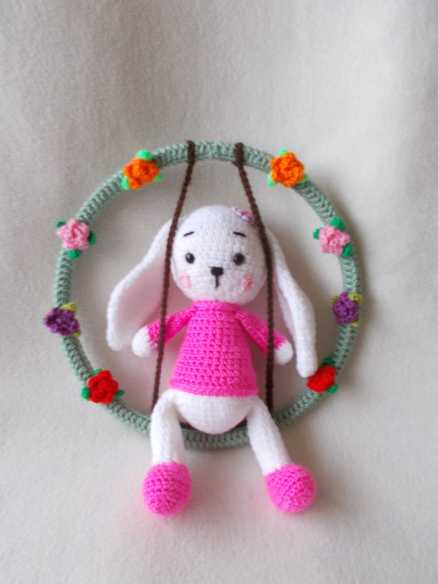 handmade crochet bunny on a swing of roses