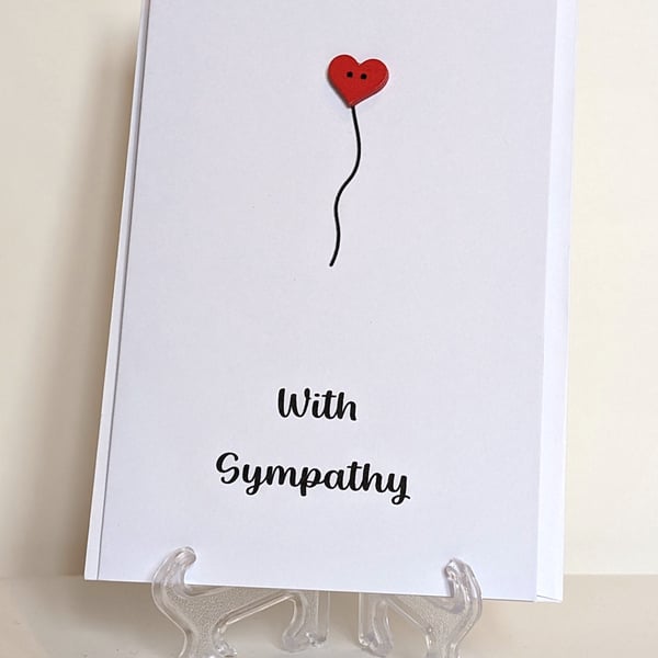 With Sympathy card with a red heart button