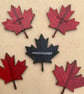 Canadian leaf shaped badge
