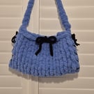 Beautiful hand knitted handbag with bow details in blue