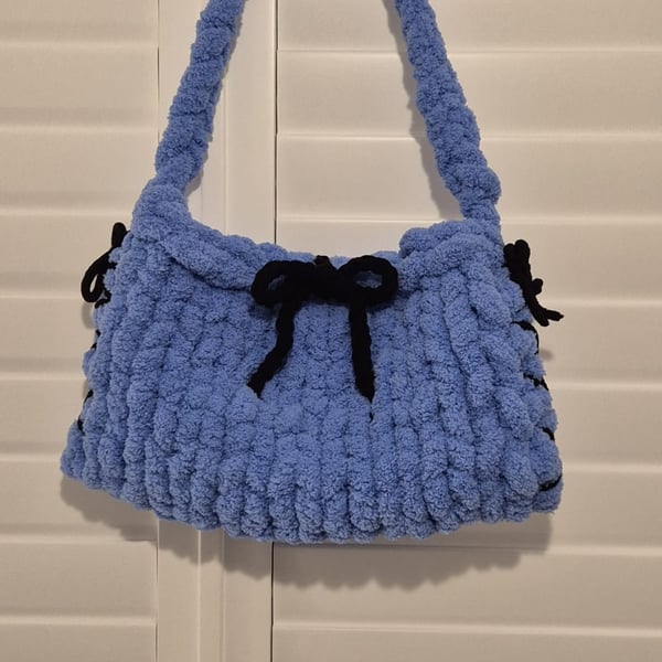 Beautiful hand knitted handbag with bow details in blue