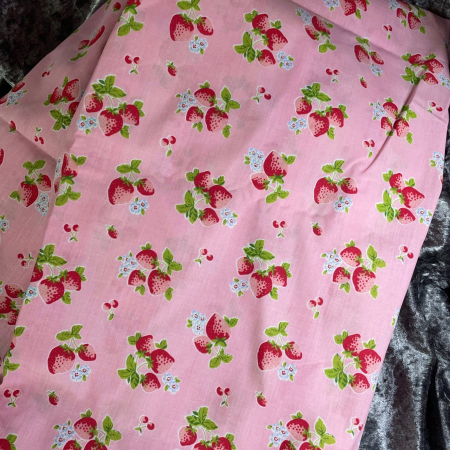 Strawberry print poly cotton on a pink background