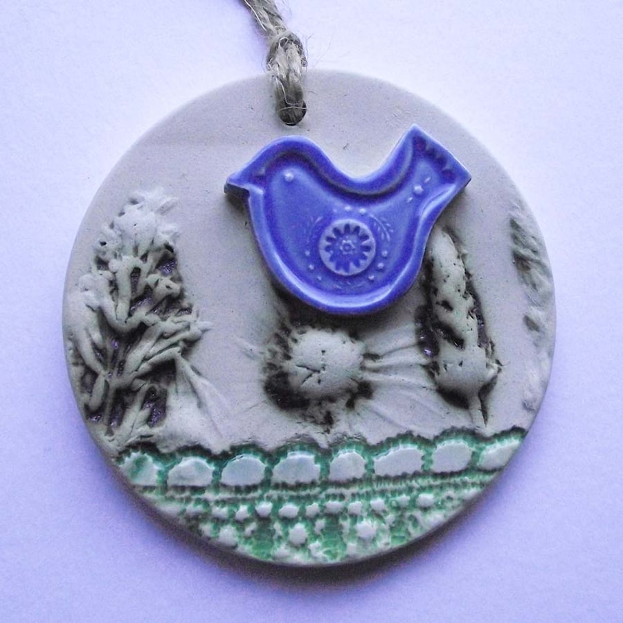 Pottery decoration with natural flower and blue bird decoration.