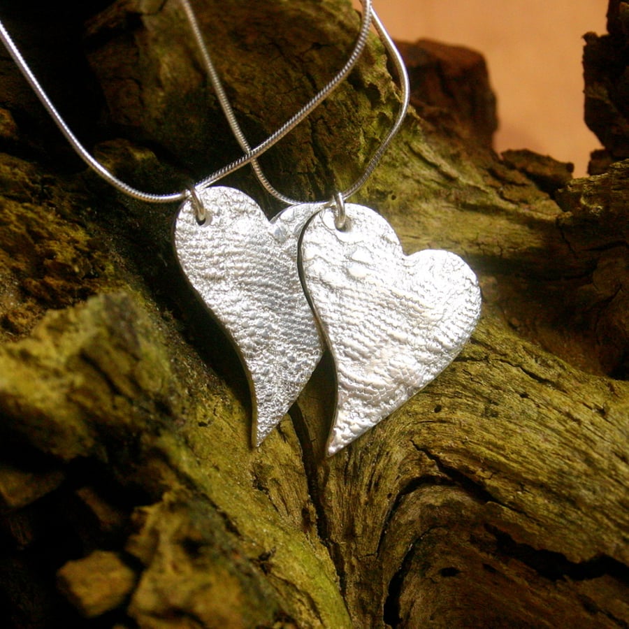 Two fine silver patterned heart pendants on sterling silver snake chains