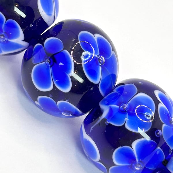 Handmade blue floral patterned lamp work glass beads