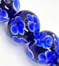 Handmade blue floral patterned lamp work glass beads - Image 1