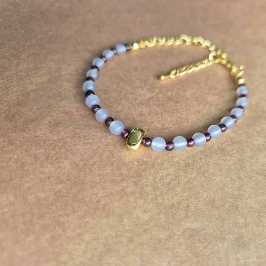 Owl grey and deep red, centre stone bracelet in gold.