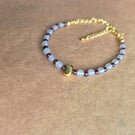 Owl grey and deep red, centre stone bracelet in gold.