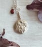 Botanical silver pendant with strawberry flower and a ruby charm. - Image 1
